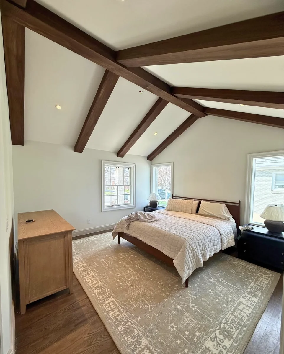 Exposed beam ceiling installation with custom staining and precise craftsmanship