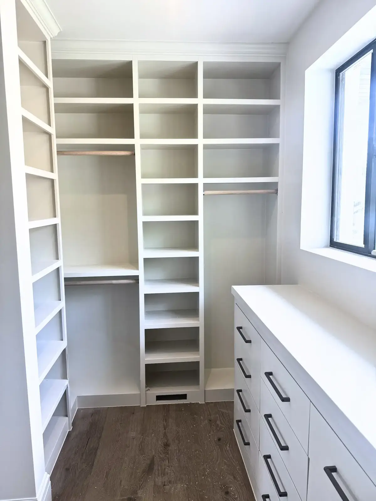 Built-in shelving unit with adjustable shelves and cabinet base
